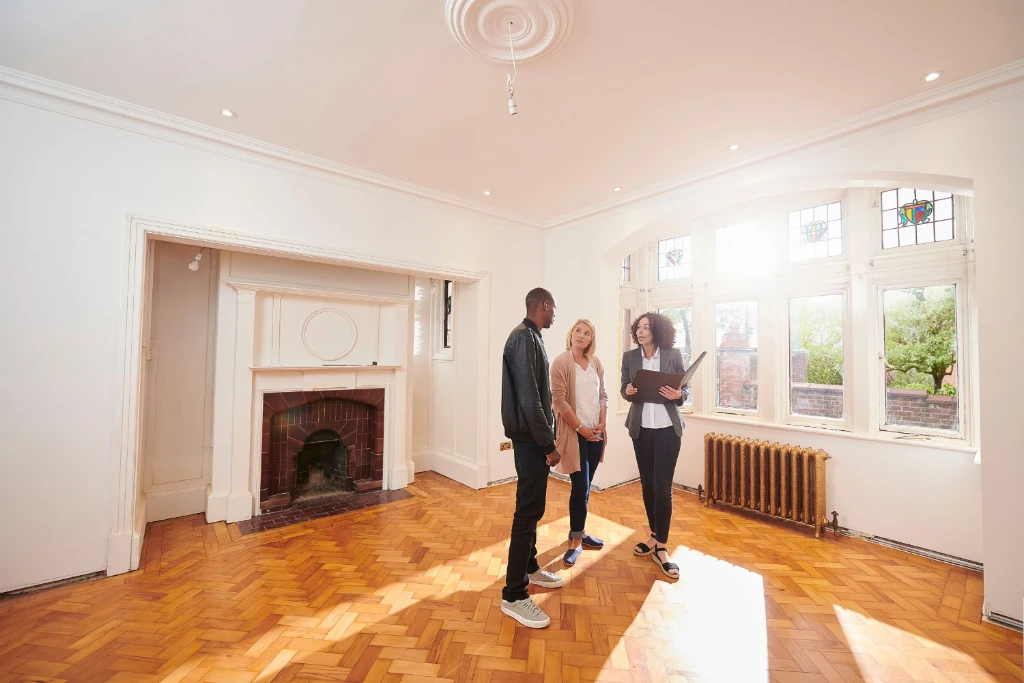 Agent showing a couple an empty property interior