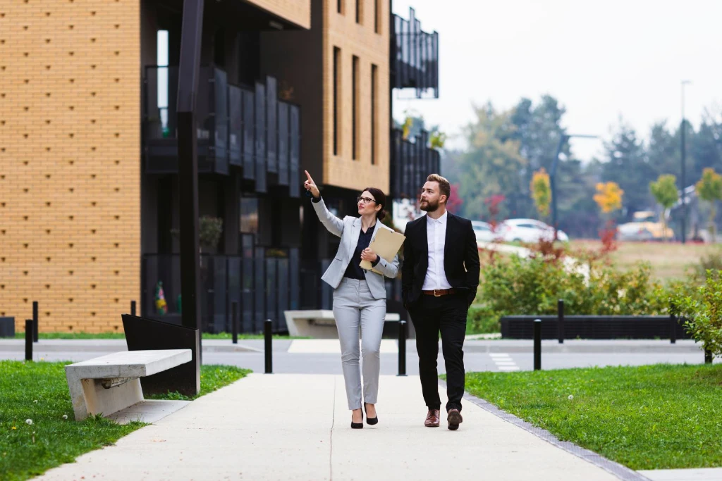Image of agent and client walking outside modern buildings in Bristol