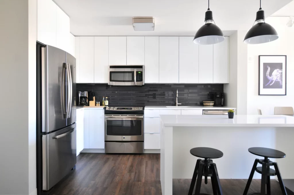 White kitchen with breakfast bar and pendant lights