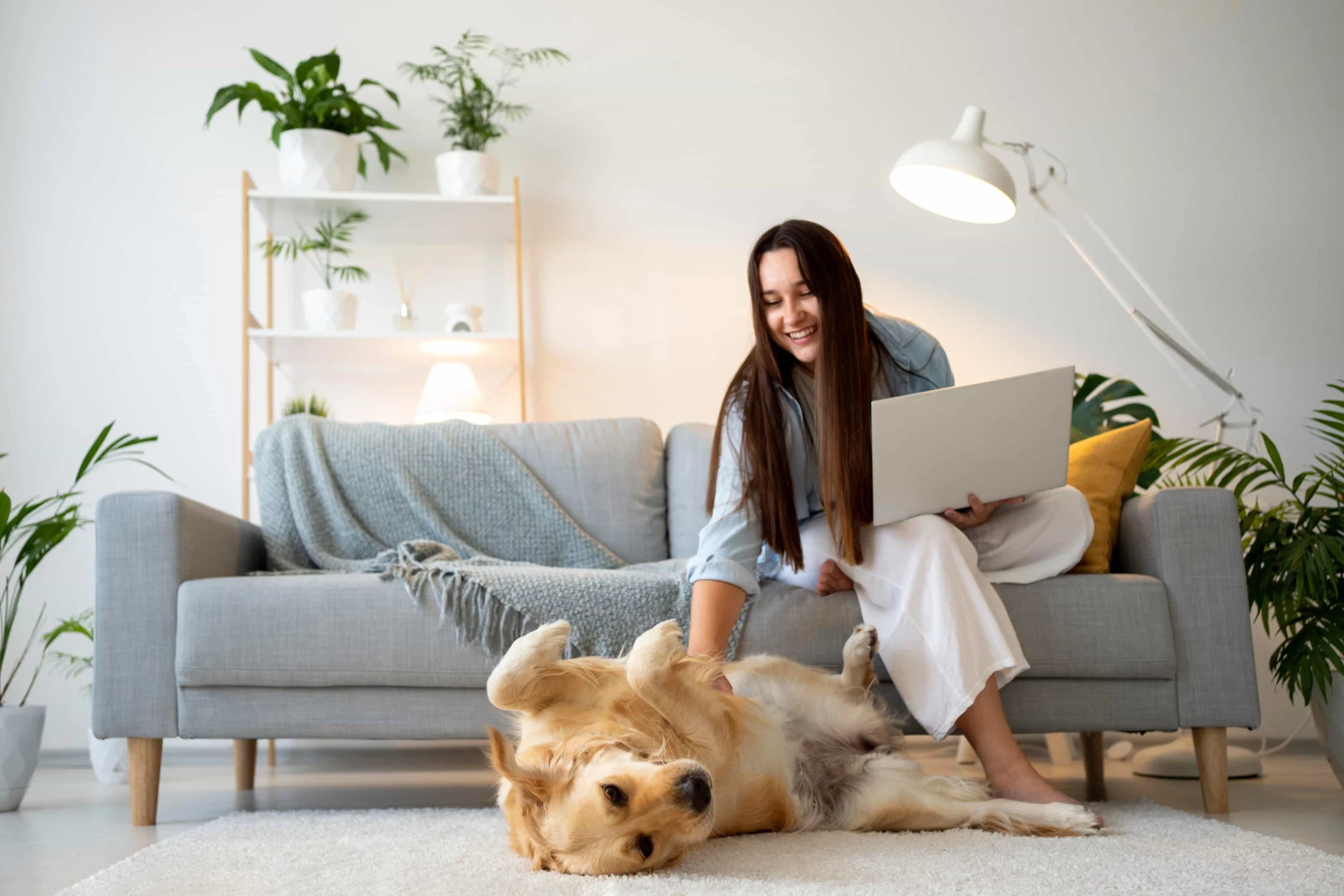Young woman working remotely with dog, showing the ease of long term property management