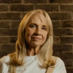 Portrait of woman with long blonde hair in soft lighting