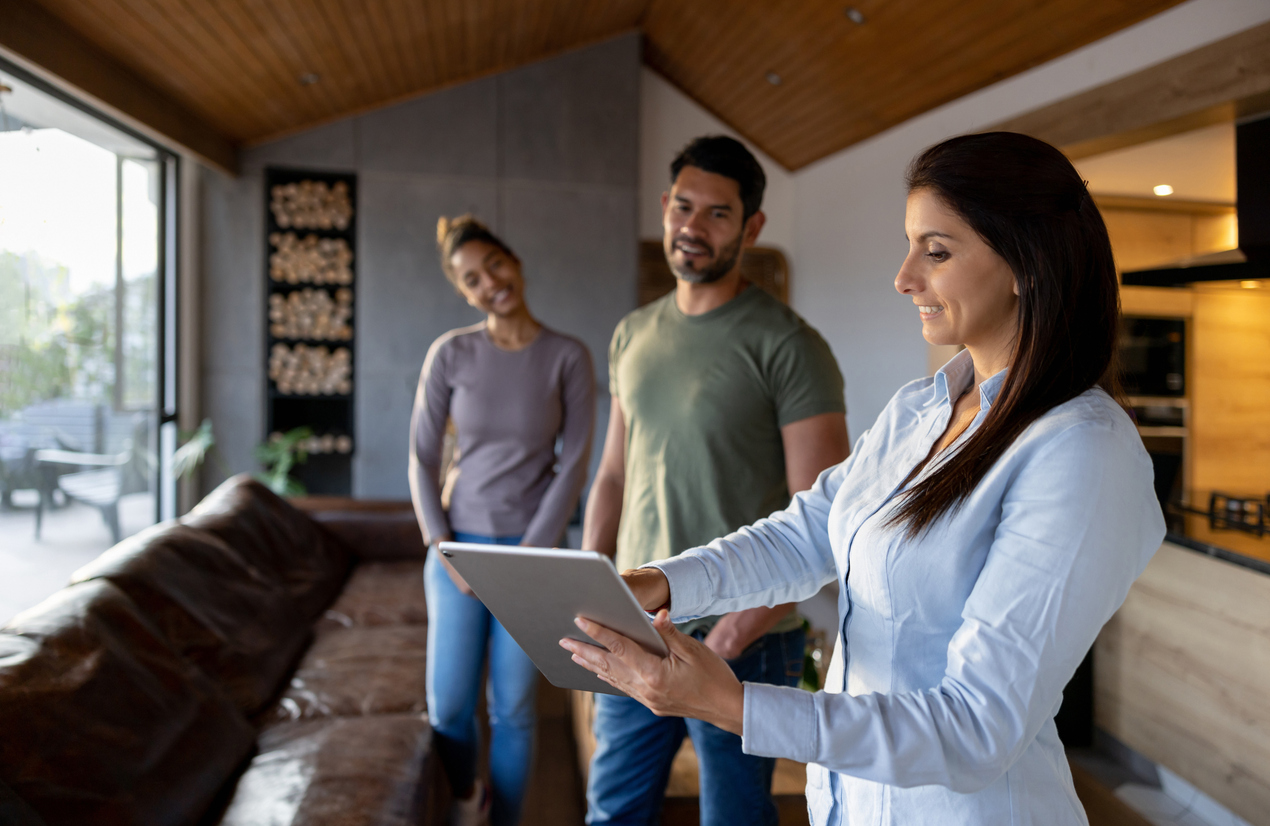 A property manager talking owners through a management plan on a tablet