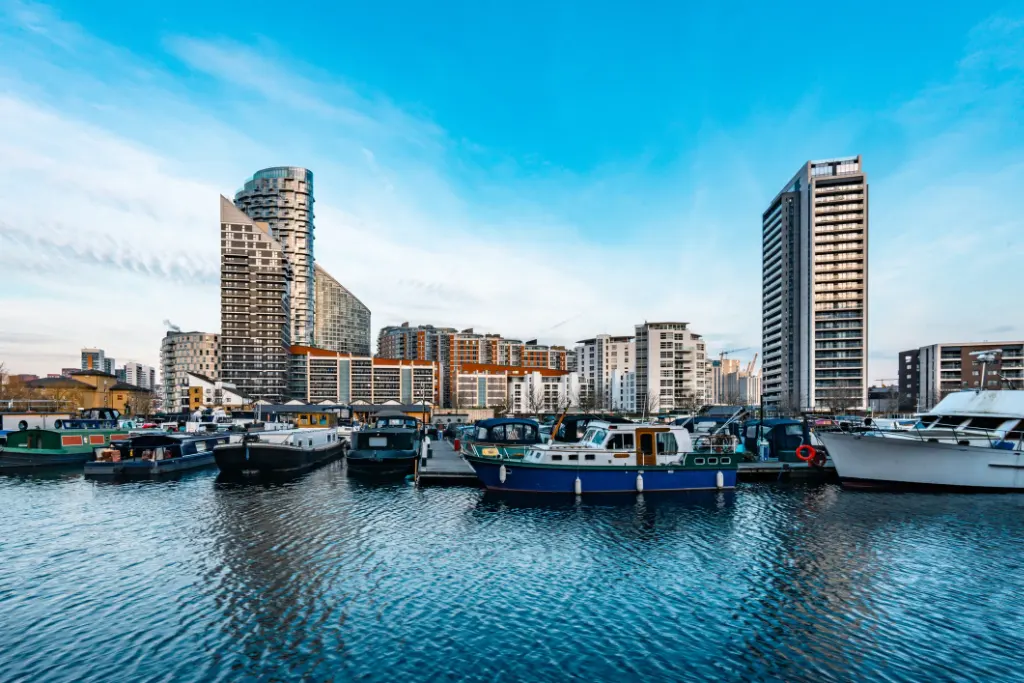 Modern residential apartment complex overlooking marina in East London Docklands with boats and waterfront views
