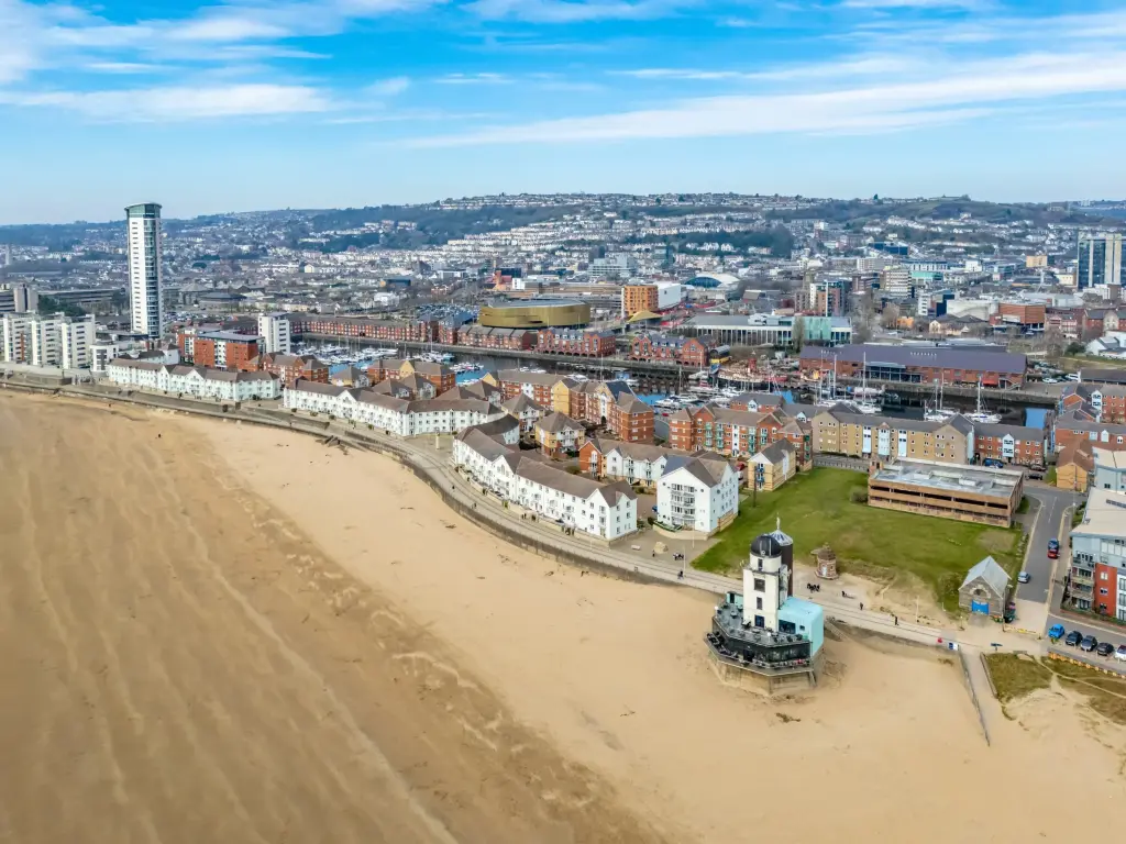 UK coastal town with beach, pier, and long sandy shoreline