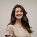 Portrait of smiling woman standing in a neutral office setting