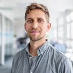 Portrait of a smiling man standing in an office environment