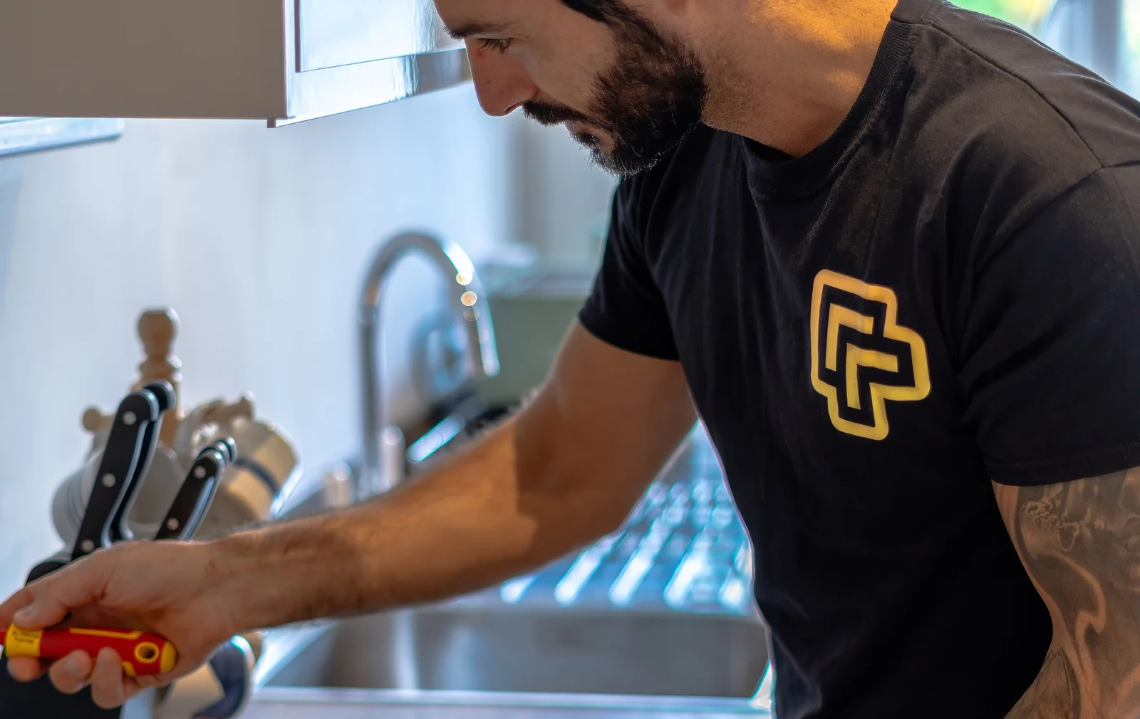 A member of the UpgradedPM maintenance team working in a managed kitchen